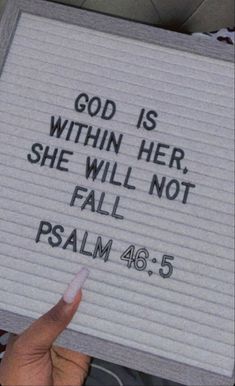 someone holding up a sign that says god is within her she will not fall psalm 46 5