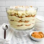 a cake sitting on top of a table covered in frosted icing and toppings