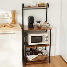 a kitchen with a microwave, toaster oven and coffee maker on the shelf next to the counter