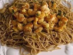 pasta with shrimp and broccoli is on a white plate