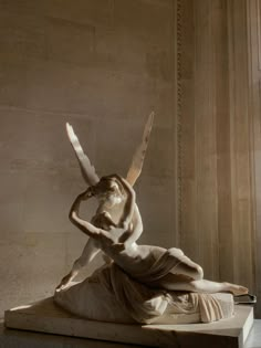 an image of a statue that is in the middle of a room with columns and walls