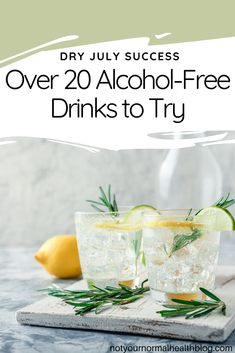 two glasses filled with alcohol sitting on top of a cutting board next to lemons and rosemary