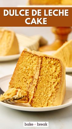 a piece of cake on a plate with a fork in it and the words dulce de leche cake above it