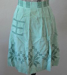 a green and white checkered skirt on a mannequin