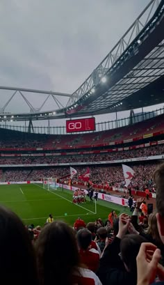 a stadium filled with people watching a soccer game