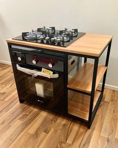 a stove top oven sitting on top of a hard wood floor