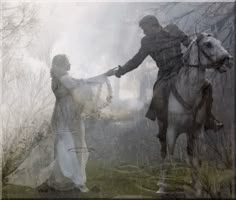 two people on horses in the fog with trees behind them and one person holding hands