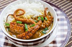 a bowl filled with meat and rice on top of a table