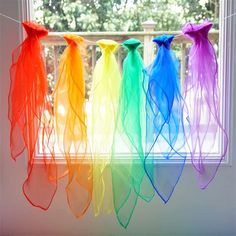 rainbow colored streamers hanging in front of a window