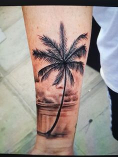 a person with a palm tree tattoo on their arm