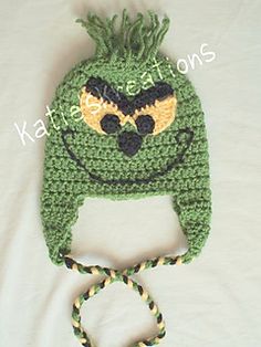 a green crocheted hat with an evil face