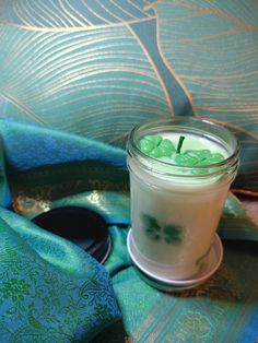 a glass jar filled with liquid sitting on top of a green cloth