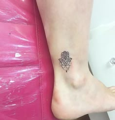 a small tattoo on the foot of a woman's feet, with an elephant