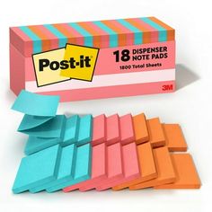 a box of post - it notes sitting on top of each other