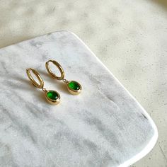 Dainty Created Emerald Gemstone Dangle Hoop Earrings Titanium 18K Gold Filled Earrings Hypoallergenic. Delicate and simple, fitting everyday wear. Stone Height: 8 mm  Stone Width: 3.5 mm Hoop inner diameter: 11 mm PRODUCT DETAIL ✧ Sold as pairs ✧ ✧ Titanium base with 18K Gold fill ✧ ✧ Nickel free Hypoallergenic and Waterproof✧ ✧ Handcrafted by our in-house jeweller✧ ✧ All packages shipped from Toronto ✧ ✧ Gift-ready packages with each order ✧ Hey! Before placing your order, why not check out oth Dainty May Birthstone Hoop Earrings, Green Hypoallergenic Huggie Earrings For Everyday, Green Hypoallergenic Everyday Huggie Earrings, Everyday Green Hypoallergenic Huggie Earrings, Green Minimalist Small Hoop Huggie Earrings, Gold Hoop Earrings For May Birthstone, Elegant Everyday Hoop Earrings With May Birthstone, Minimalist Green Hoop Huggie Earrings, Green Minimalist Huggie Hoop Earrings