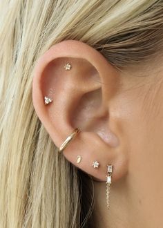 a close up of a person wearing ear piercings