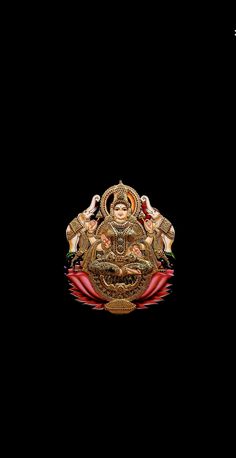 an image of the god ganesh in gold on a black background with red accents