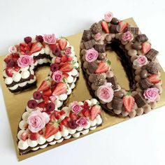 a cake shaped like the number twenty five with strawberries and flowers on it, sitting on a gold plate