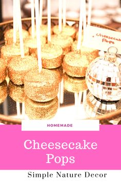 homemade cheesecake pops on a plate with candles in the middle and a disco ball next to it