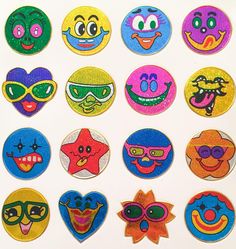 a bunch of different colored patches with faces on them