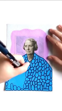 a person is holding a marker and drawing a picture on paper with blue circles around it