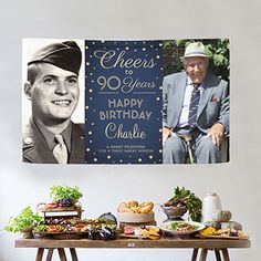 a table topped with food next to a sign that reads cheers 90 years happy birthday charlie