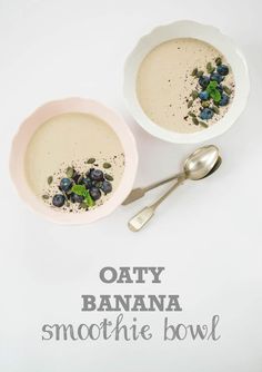 two bowls of oaty banana smoothie bowl with blueberries and mint sprinkles