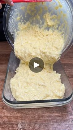 a person mixing batter in a bowl with a red spatula on the top of it