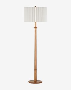 a wooden floor lamp with a white shade