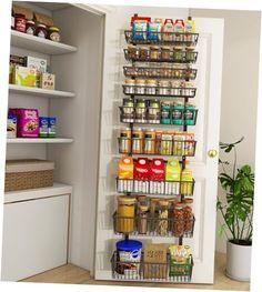 a pantry door is open to reveal the food in it's storage compartment and shelves