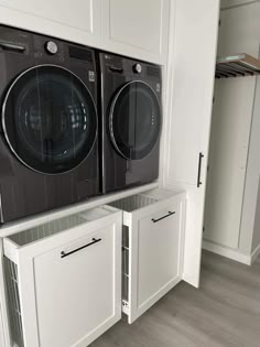 the washer and dryer are sitting in the cabinet space next to each other