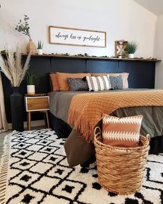 a bedroom with a large bed and baskets on the floor in front of it's headboard