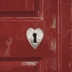 a red door with a heart shaped keyhole and a lock on the front panel