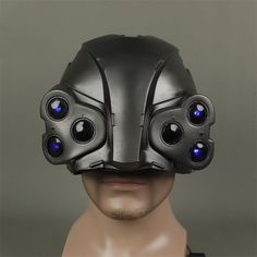 a man wearing a helmet with speakers on it's face and his eyes glowing