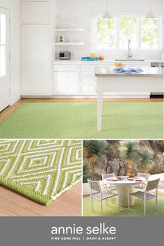 a kitchen with white cabinets and green rugs on the floor next to a dining room table