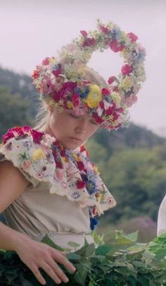 a woman wearing a flowered head wreath