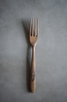 a wooden fork sitting on top of a table