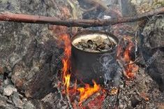 a pot is sitting on fire in the woods