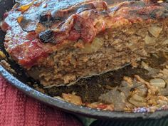 meatloaf in a skillet on top of a red towel