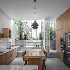 an open kitchen and dining area with wooden cabinets