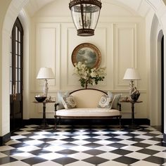 an elegant living room with black and white checkered flooring