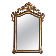 an ornate gold framed mirror against a white background