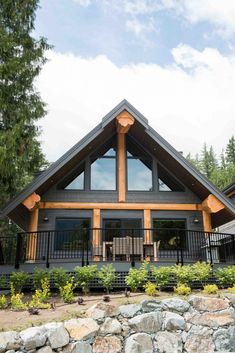 a large house with lots of windows and wood trimmings on the front porch