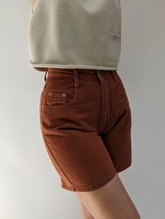 Vintage high rise denim short in a beautiful burnt sienna colored denim fabric. Sweet paired with our Milo Pima Cotton Vest. Tag reads Forelli Denim / Made in USA If you would like additional info or images prior to final sale purchase please reach out to vintage@naninstudio.com. Vintage items may come with minor flaws due to pre loved wear. Color of product may slightly vary compared to photo due to lighting. Please enjoy and appreciate this item with its character. Vintage items are FINAL SALE Cotton Jean Shorts With Pockets, High Waist Jean Shorts For Fall With Pockets, Fall High Waist Jean Shorts With Pockets, Jean Shorts With Pockets For Fall, Fall Jean Shorts With Pockets, High-waisted Jean Shorts For Fall With Pockets, Brown Cotton Shorts For Fall, Fall Season Jean Shorts With Pockets, Trendy Shorts For Fall