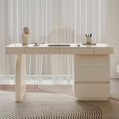 a white desk with two drawers in front of a curtained window and a rug on the floor