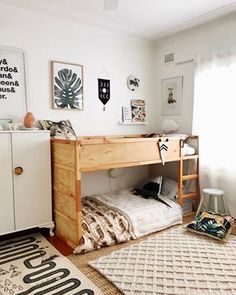 a bedroom with a bunk bed and rugs on the floor