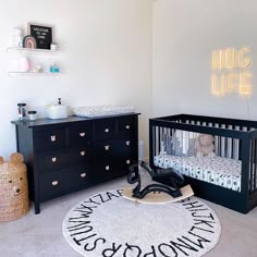 a baby's room with a crib, dresser and changing table in it