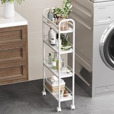 a washing machine and shelving unit in a bathroom