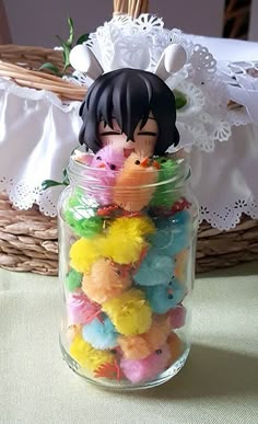 a glass jar filled with lots of small stuffed animals