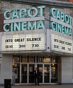 a movie theater with two men standing outside